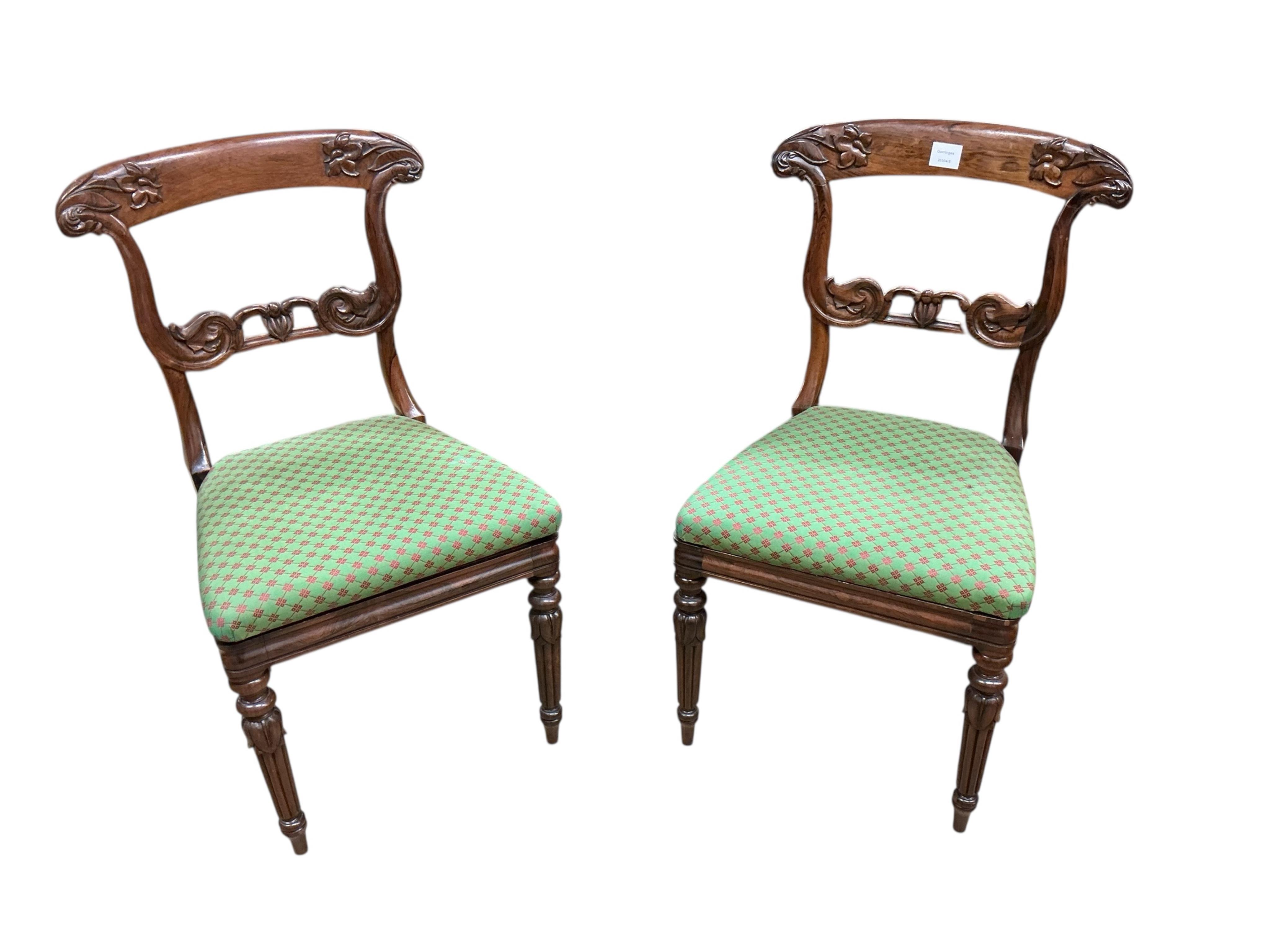 A pair of William IV rosewood dining chairs, with foliate carved decoration to the back supports, width 49cm, height 86cm